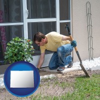 a landscape contractor working on a landscaping project - with CO icon